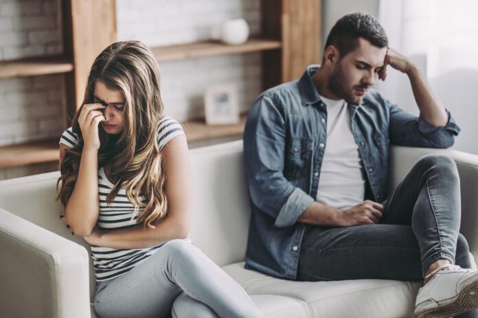 Upset couple at home.